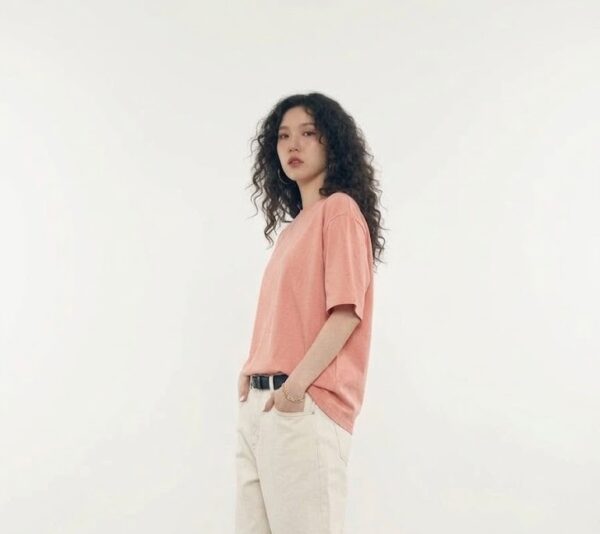 twinfish model wearing salmon pink oversized tee in studio